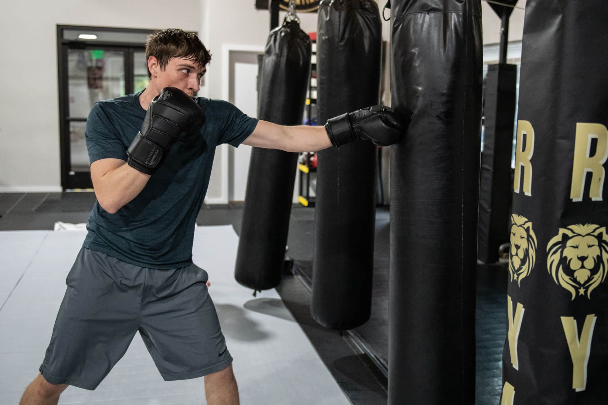 boxing student hitting punching bag for boxing class warm ups at Royal Mixed Martial Arts