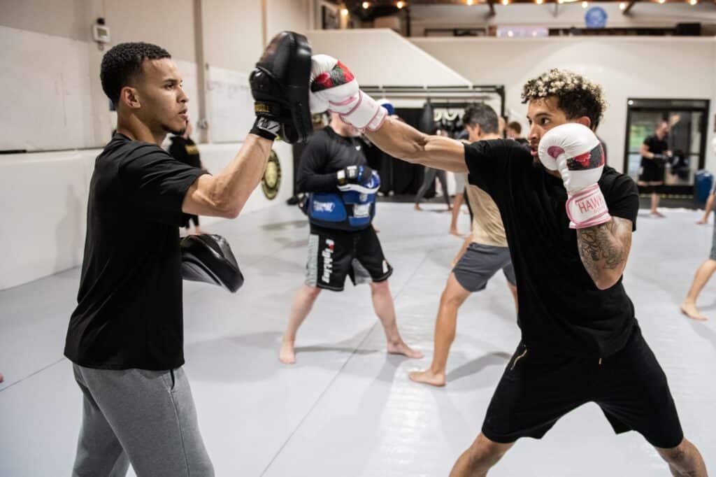 Royal Mixed Martial Arts Boxing Class one student with boxing gloves practicing with another student